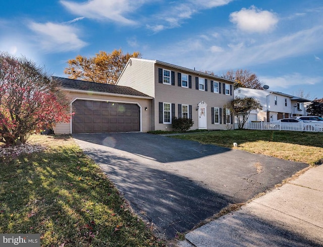 view of front of property featuring a garage and a front yard