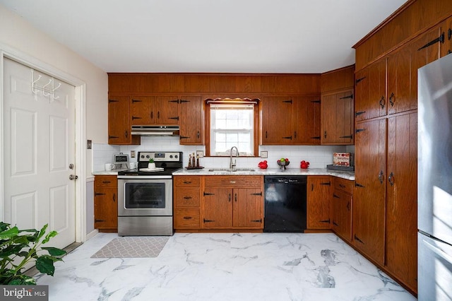 kitchen featuring stainless steel appliances, sink, and backsplash