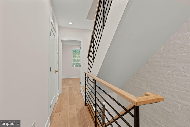 hallway with light hardwood / wood-style floors