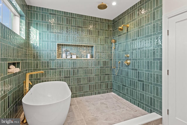 bathroom with tile walls and shower with separate bathtub