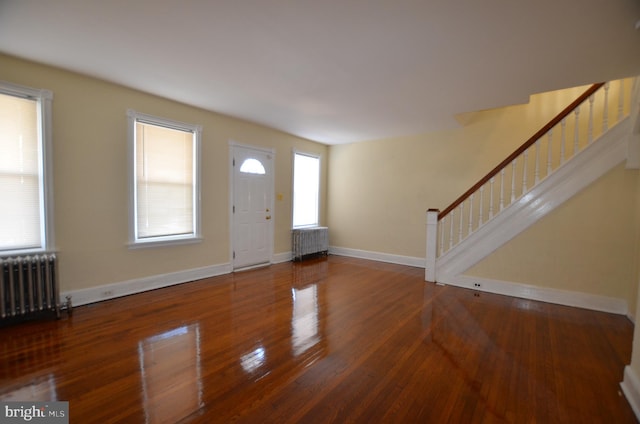 foyer featuring radiator heating unit and hardwood / wood-style flooring