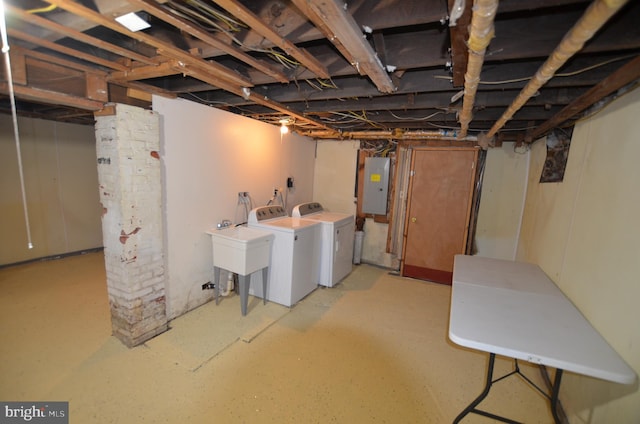 basement with electric panel, sink, and washing machine and clothes dryer