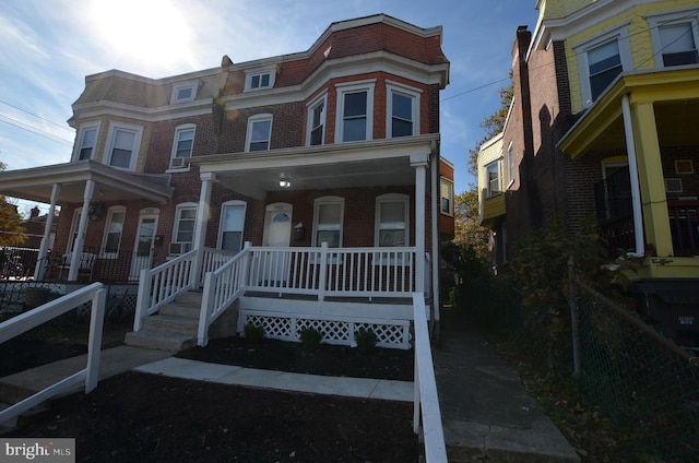 townhome / multi-family property featuring a porch