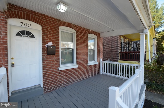 wooden terrace featuring covered porch