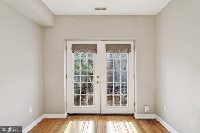 doorway to outside with french doors and light wood-type flooring