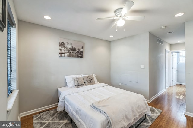 bedroom with dark wood-type flooring and ceiling fan