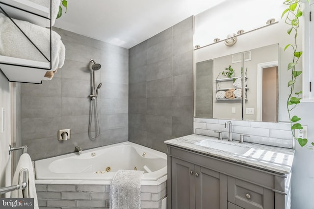 bathroom featuring vanity and a relaxing tiled tub