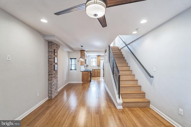 stairway with hardwood / wood-style flooring