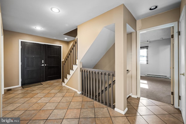 carpeted entryway with a baseboard radiator