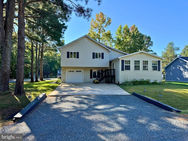 view of front of house with a garage and a front yard