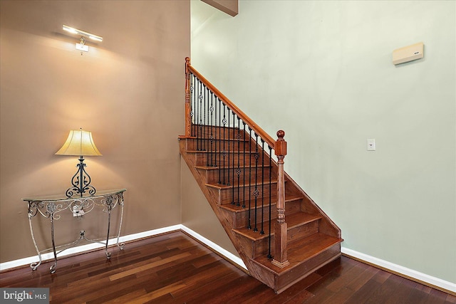 stairway with hardwood / wood-style flooring