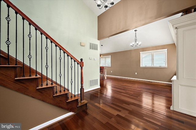 39 Admiral Ave, Ocean Pines, MD 21811 - staircase with a chandelier, hardwood / wood-style flooring, baseboards, and vaulted ceiling