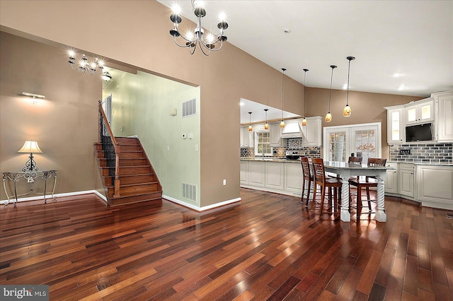 39 Admiral Ave, Ocean Pines, MD 21811 - kitchen with vaulted ceiling, a chandelier, tasteful backsplash, dark wood-style floors, and white cabinets