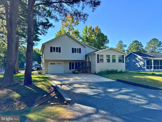 view of front of home featuring a front yard and a garage