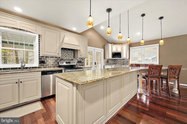 39 Admiral Ave, Ocean Pines, MD 21811 - kitchen featuring stainless steel appliances, a sink, backsplash, light stone counters, and dark wood-style flooring