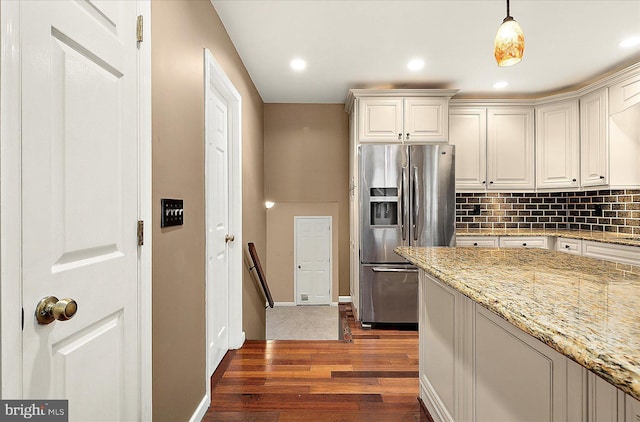 39 Admiral Ave, Ocean Pines, MD 21811 - kitchen with stainless steel fridge with ice dispenser, dark wood-style floors, tasteful backsplash, hanging light fixtures, and baseboards