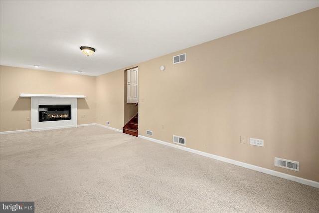 39 Admiral Ave, Ocean Pines, MD 21811 - unfurnished living room featuring stairway, baseboards, a glass covered fireplace, and light carpet