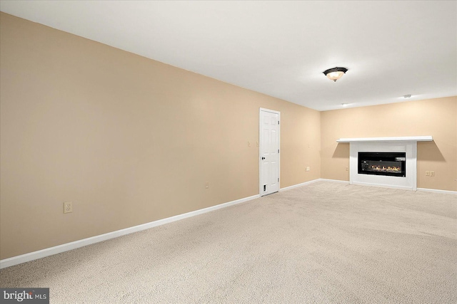 39 Admiral Ave, Ocean Pines, MD 21811 - unfurnished living room with baseboards, a glass covered fireplace, and carpet flooring