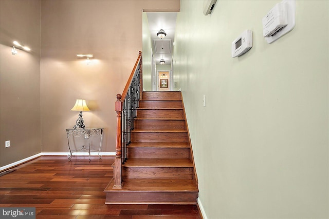 stairway featuring wood-type flooring