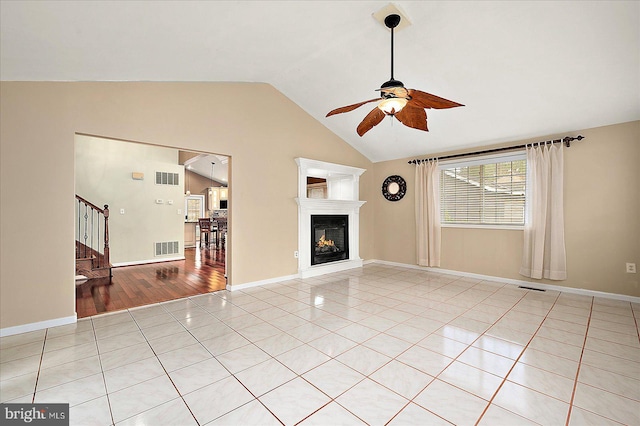 unfurnished living room with light hardwood / wood-style floors, ceiling fan, and lofted ceiling