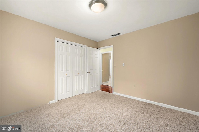 unfurnished bedroom with carpet and a closet