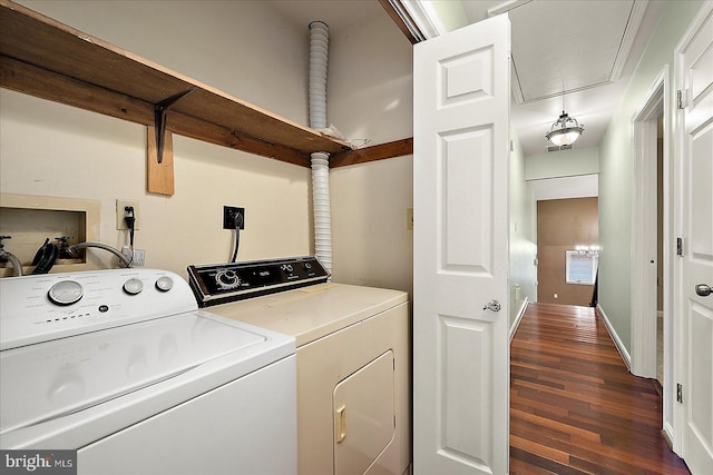 washroom with dark wood-type flooring and washing machine and clothes dryer