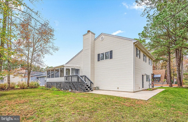 39 Admiral Ave, Ocean Pines, MD 21811 - rear view of house with a sunroom, a patio area, a yard, and a chimney
