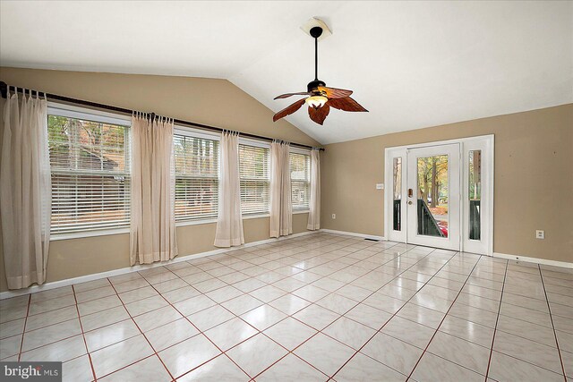 tiled empty room featuring vaulted ceiling, a wealth of natural light, and ceiling fan