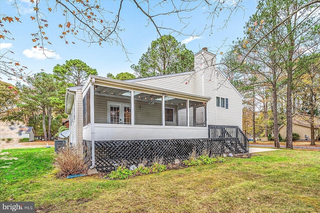 39 Admiral Ave, Ocean Pines, MD 21811 - view of front facade with a sunroom, a front yard, and a chimney