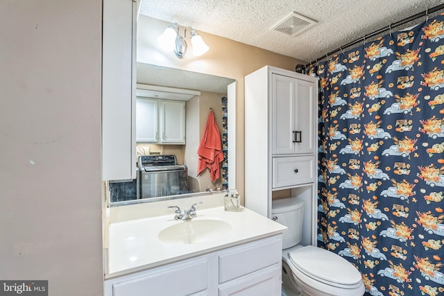 bathroom featuring vanity, a textured ceiling, and toilet