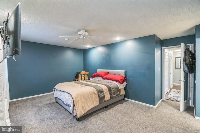 carpeted bedroom featuring a textured ceiling and ceiling fan