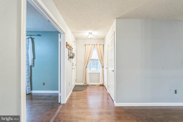 foyer with dark hardwood / wood-style flooring and a textured ceiling