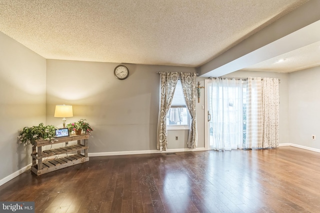 empty room featuring hardwood / wood-style floors and a textured ceiling