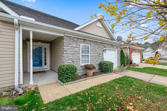 view of exterior entry with a garage