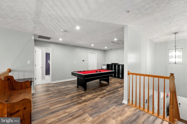 rec room featuring dark hardwood / wood-style flooring, pool table, and a textured ceiling