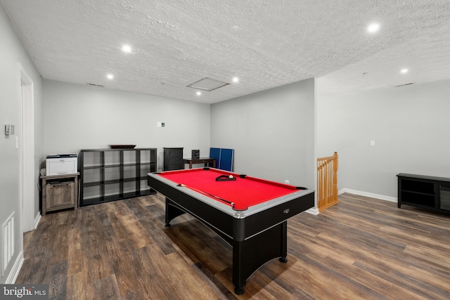 game room with dark wood-type flooring, a textured ceiling, and billiards