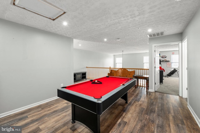 recreation room featuring billiards, dark hardwood / wood-style floors, a textured ceiling, and a wealth of natural light