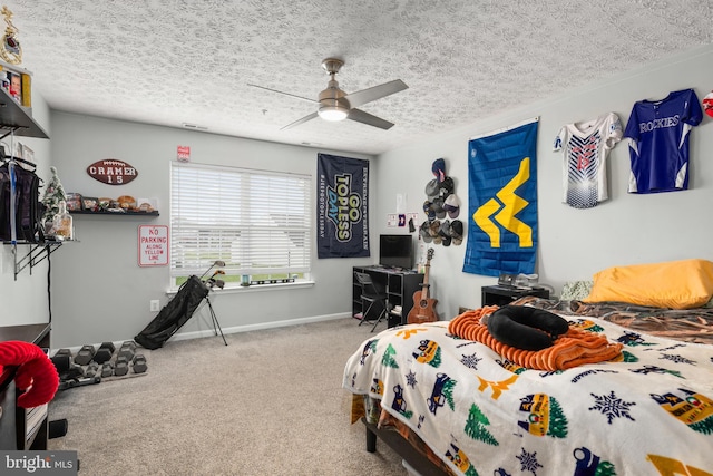 bedroom featuring carpet, ceiling fan, and a textured ceiling