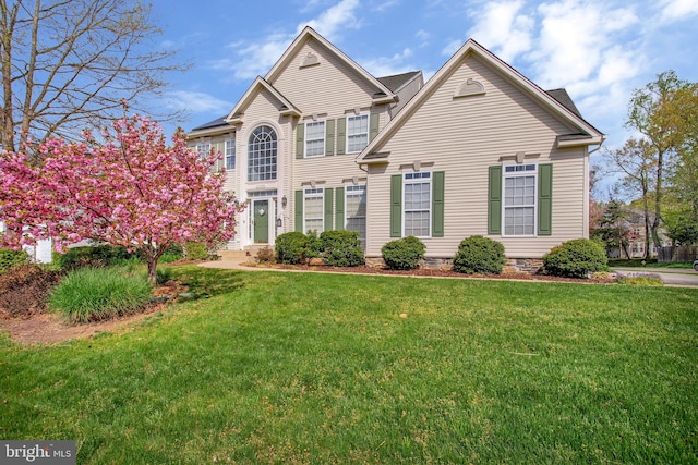 view of property featuring a front lawn