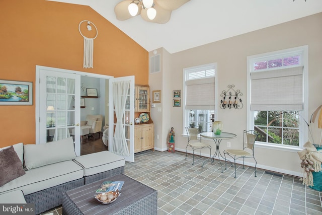 living room featuring ceiling fan and high vaulted ceiling