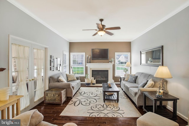 living room with ornamental molding, dark wood-type flooring, and a wealth of natural light