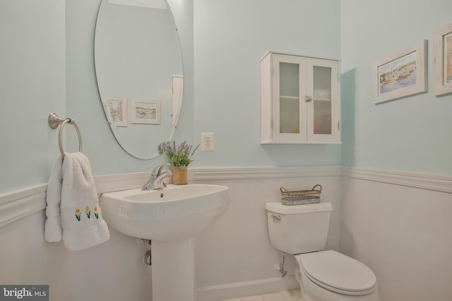 bathroom featuring toilet and tile patterned flooring