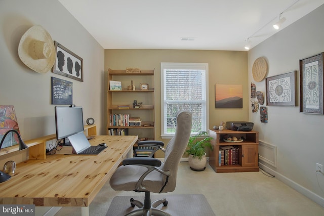 office space featuring light carpet and track lighting