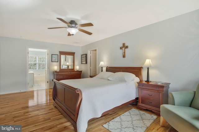 bedroom with ensuite bathroom, light hardwood / wood-style floors, and ceiling fan