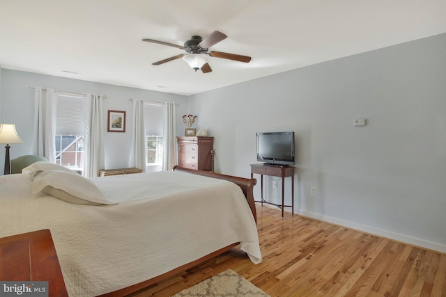 bedroom with ceiling fan and light hardwood / wood-style floors