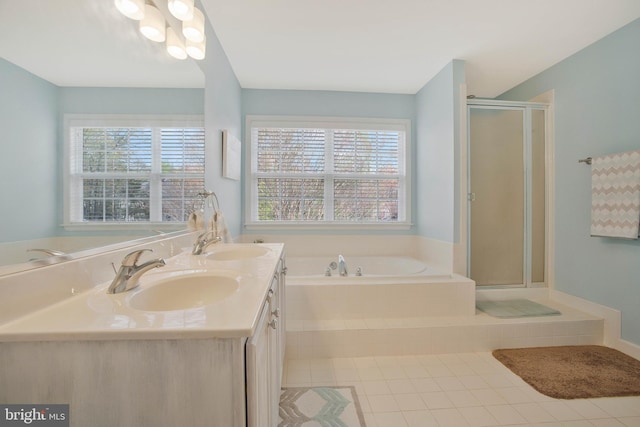 bathroom with vanity, tile patterned floors, independent shower and bath, and a wealth of natural light