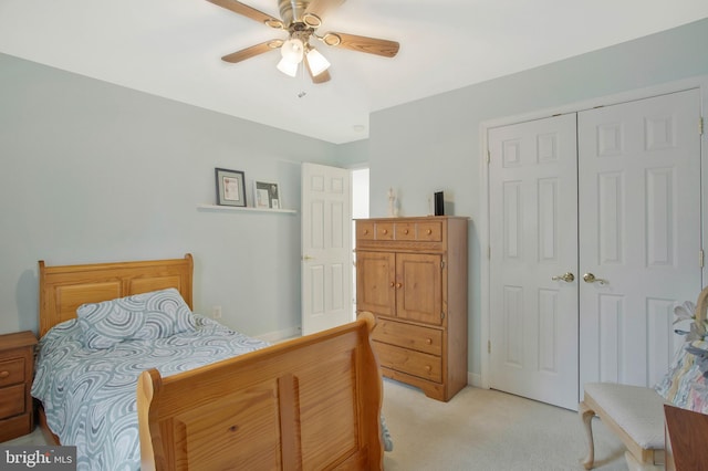 carpeted bedroom featuring a closet and ceiling fan