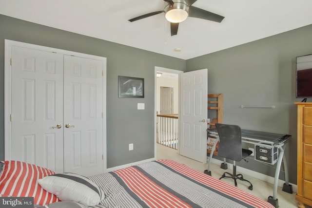 carpeted bedroom featuring a closet and ceiling fan