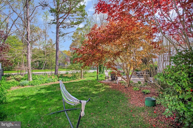 view of home's community with a patio area and a lawn