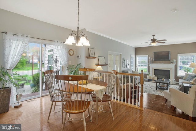 dining room featuring ornamental molding, ceiling fan with notable chandelier, and hardwood / wood-style floors